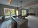 Modern kitchen with island and open layout to Gathering room at 1534 Stargrass Dr, Grayson, GA 30017