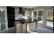 Modern kitchen with dark cabinetry, a large island, and stainless steel appliances at 1534 Stargrass Dr, Grayson, GA 30017