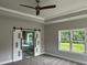Spacious main bedroom with a barn door leading to the ensuite bathroom at 1534 Stargrass Dr, Grayson, GA 30017