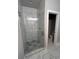 Spa-like shower with marble tile and glass enclosure at 1534 Stargrass Dr, Grayson, GA 30017