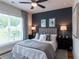 Spacious bedroom with dark accent wall, ceiling fan, and hardwood floors at 548 Sawnee Village Blvd # D72, Cumming, GA 30040