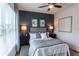 Spacious bedroom with dark accent wall, ceiling fan, and hardwood floors at 548 Sawnee Village Blvd # D72, Cumming, GA 30040