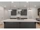 Modern kitchen with dark cabinetry, quartz countertops, and stainless steel appliances at 548 Sawnee Village Blvd # D72, Cumming, GA 30040