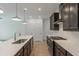 Modern kitchen with dark cabinetry, quartz countertops, and stainless steel appliances at 548 Sawnee Village Blvd # D72, Cumming, GA 30040