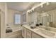 Elegant bathroom featuring double vanity and soaking tub at 1613 Aiden Way # 54, Conyers, GA 30013