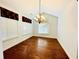 Bright dining room with hardwood floors and elegant chandelier at 4140 Lanier Ridge Walk # 104, Cumming, GA 30041