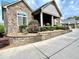 Charming home featuring a stone facade, flower beds, and a welcoming covered porch at 4140 Lanier Ridge Walk # 104, Cumming, GA 30041