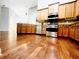 Kitchen with wood cabinets, granite countertops, and stainless steel appliances at 4140 Lanier Ridge Walk # 104, Cumming, GA 30041