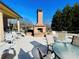 Outdoor patio with a brick fireplace and seating area at 4140 Lanier Ridge Walk # 104, Cumming, GA 30041