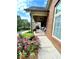 Covered porch with brick flooring and lush landscaping at 4140 Lanier Ridge Walk # 104, Cumming, GA 30041