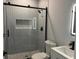 Contemporary bathroom with grey tile shower and sleek fixtures at 935 Pelham Nw St, Atlanta, GA 30318