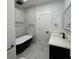 Modern bathroom with marble tile and freestanding bathtub at 935 Pelham Nw St, Atlanta, GA 30318