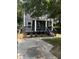 Two-story gray house with a front porch, steps, and driveway at 935 Pelham Nw St, Atlanta, GA 30318