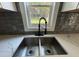 Modern kitchen sink and faucet with grey backsplash at 935 Pelham Nw St, Atlanta, GA 30318
