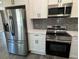 Stainless steel appliances and white shaker cabinets at 935 Pelham Nw St, Atlanta, GA 30318