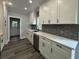 Modern kitchen with white cabinets and stainless steel appliances at 935 Pelham Nw St, Atlanta, GA 30318