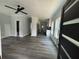 Open concept living room and kitchen with grey flooring and ceiling fan at 935 Pelham Nw St, Atlanta, GA 30318