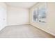 Well-lit bedroom with carpeted floor and large window at 189 Aylesbury Blvd, Mcdonough, GA 30252