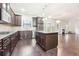 Modern kitchen with dark wood cabinets, granite countertops, and an island at 189 Aylesbury Blvd, Mcdonough, GA 30252