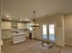 Kitchen features an island, white cabinets, and French doors at 4220 Easter Lily Ave, Buford, GA 30519