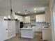 Modern kitchen featuring white cabinets, quartz countertops, and a large island at 4220 Easter Lily Ave (Lot3), Buford, GA 30519
