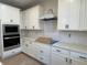 Modern kitchen with white cabinets, quartz countertops and stainless steel appliances at 4220 Easter Lily Ave (Lot3), Buford, GA 30519