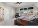 Bedroom with carpet, ceiling fan, large window, and a dark wood bed frame at 924 Wemberley Ln, Marietta, GA 30064