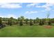 Expansive backyard featuring a lush lawn, privacy fence, and young trees enhancing the serene outdoor space at 1646 Tide Mill Rd, Cumming, GA 30040