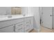 Bright bathroom featuring double sink vanity with neutral tile floor at 1646 Tide Mill Rd, Cumming, GA 30040