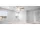 This bedroom features neutral carpet, two windows with blinds, and a ceiling fan at 1646 Tide Mill Rd, Cumming, GA 30040