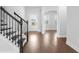 Inviting foyer featuring wood flooring, a staircase with black iron railings, and a front door at 1646 Tide Mill Rd, Cumming, GA 30040