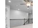 The upstairs hallway has iron railings and carpet at 1646 Tide Mill Rd, Cumming, GA 30040