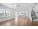 Open-concept living room flows into kitchen, with hardwood floors and ample natural light at 1646 Tide Mill Rd, Cumming, GA 30040
