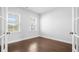 Well-lit office space with hardwood floors, French doors, and two windows at 1646 Tide Mill Rd, Cumming, GA 30040