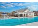 Community pool featuring a splash fountain and sunbathing area with a covered pavilion at 1646 Tide Mill Rd, Cumming, GA 30040