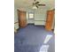Bedroom with blue carpet, ceiling fan and double door closets at 2006 Goode Rd, Conyers, GA 30094