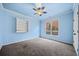 Bedroom with blue walls, gray carpet, and built-in shelving at 2870 The Terraces Way, Dacula, GA 30019
