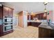 Spacious kitchen with dark wood cabinets and granite countertops at 2870 The Terraces Way, Dacula, GA 30019