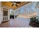 Covered patio with tile flooring, ceiling fan, and wooded views at 2870 The Terraces Way, Dacula, GA 30019