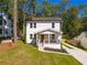 Two-story white farmhouse with a front porch and a large yard at 2880 Joyce Ave, Decatur, GA 30032