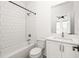 Simple bathroom with white subway tile, white vanity, and a bathtub at 2606 Talley St, Decatur, GA 30030