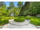 Serene backyard with meticulously shaped hedges, stone accents, and a charming playhouse for outdoor enjoyment at 3685 Paces Ferry Nw Rd, Atlanta, GA 30327
