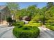 Lush backyard featuring manicured hedges, stone pathways, and mature trees, creating a private oasis at 3685 Paces Ferry Nw Rd, Atlanta, GA 30327