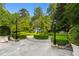 Landscaped backyard featuring trimmed hedges, stone features, and stylish lighting, enhancing its appeal and charm at 3685 Paces Ferry Nw Rd, Atlanta, GA 30327