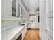 Well-appointed butler's pantry with marble countertops and ample storage at 3685 Paces Ferry Nw Rd, Atlanta, GA 30327