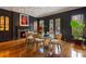 Formal dining room features dark walls, custom millwork, a fireplace, and French doors at 3685 Paces Ferry Nw Rd, Atlanta, GA 30327