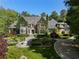 Stunning stone home with an ivy-covered facade and manicured front lawn and garden at 3685 Paces Ferry Nw Rd, Atlanta, GA 30327