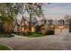 Grand two-story stone home with manicured front yard and dual garages at 3685 Paces Ferry Nw Rd, Atlanta, GA 30327