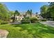 Stone mansion with ivy-covered walls, lush landscaping, and a circular driveway in a prime location at 3685 Paces Ferry Nw Rd, Atlanta, GA 30327