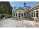 Exterior of home featuring a glass-domed sunroom and landscaped patio at 3685 Paces Ferry Nw Rd, Atlanta, GA 30327
